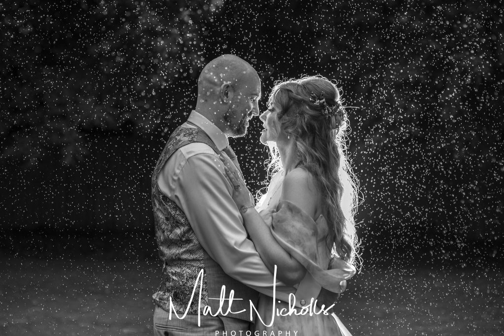 Bride and Groom in the rain at Camblesforth Hall wedding venue